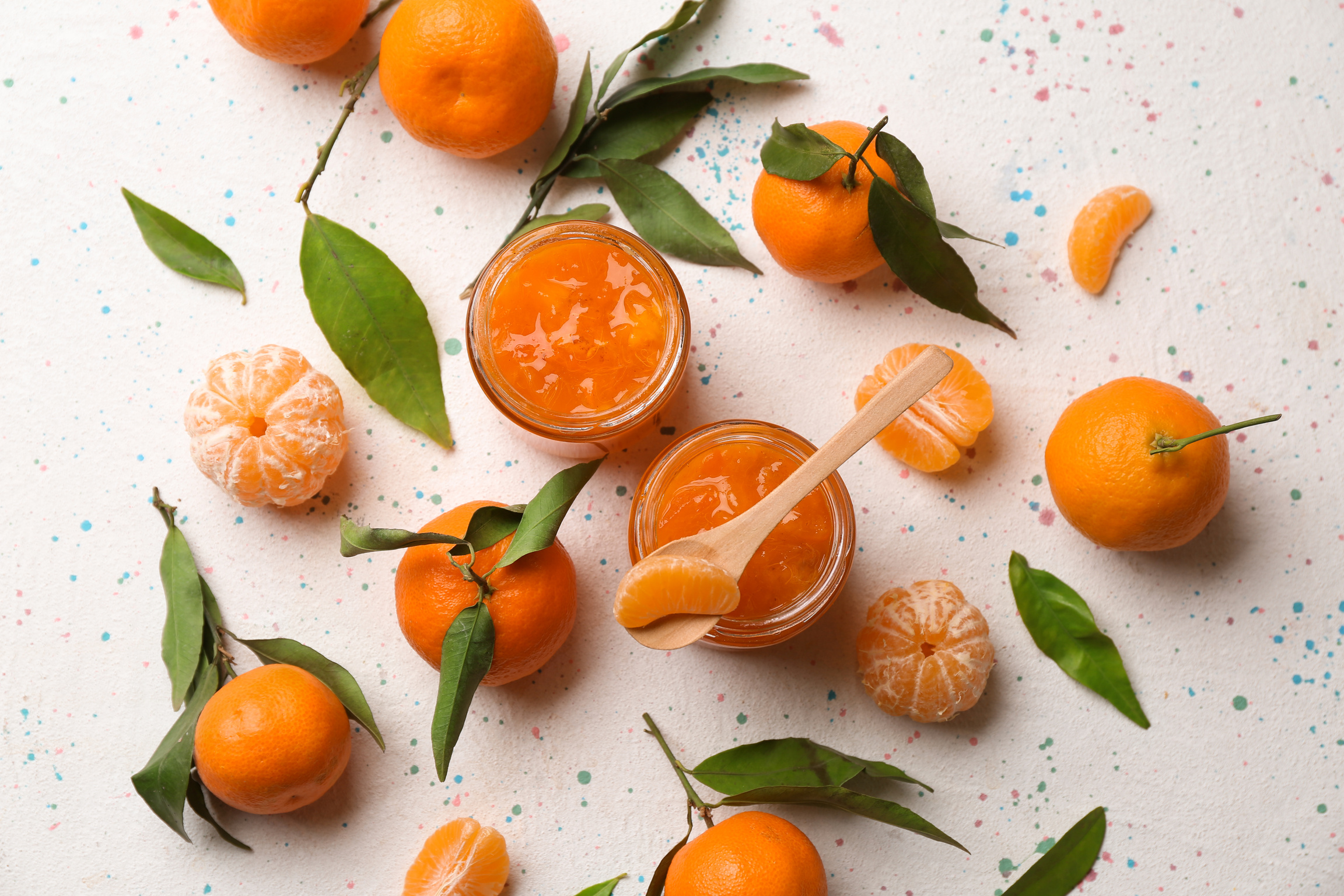 Composition of Jars with Tangerine Jam on White Background